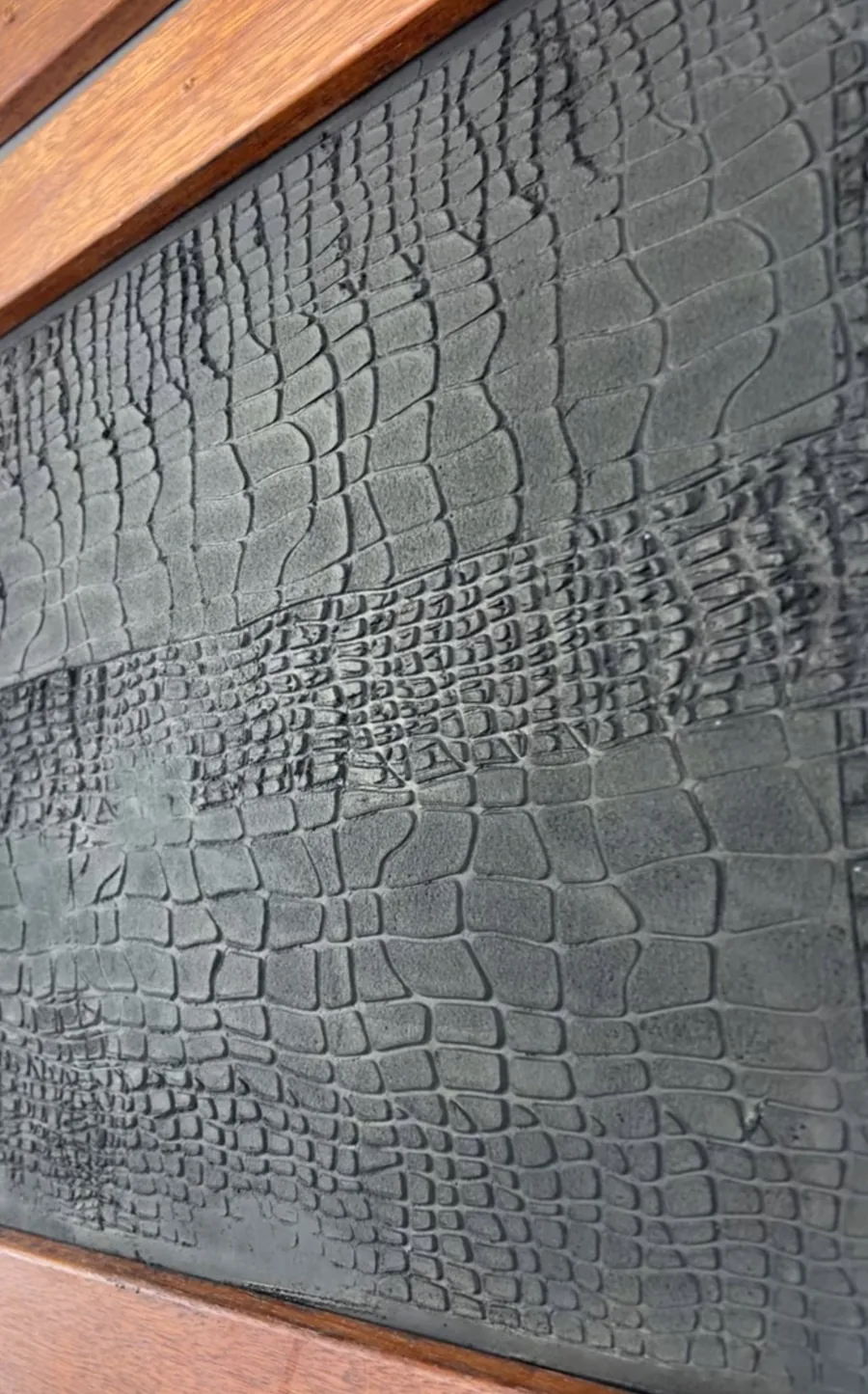 Crocodile skin textured plaster panel in dark grey